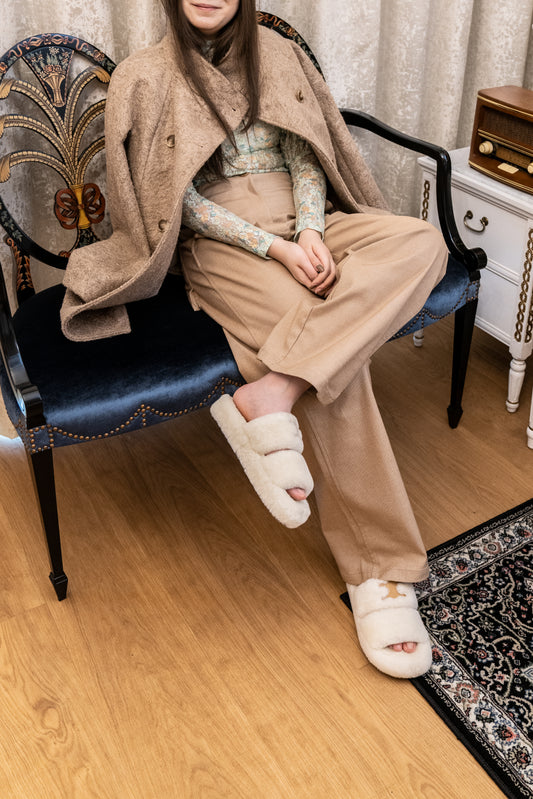 This is a brown coat made of wool. It is light brown. It is rather long, like a trench coat. It is lightweight and comfortable to wear in Autumn and Winter. You can pair it with long brown pants and a pair of furry flipflops. 