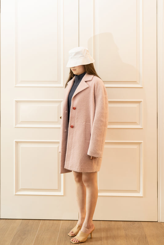 Our model wearing a white fishermen hat and a pair of high heels with our WOOL-BLEND COAT (BABY PINK).
